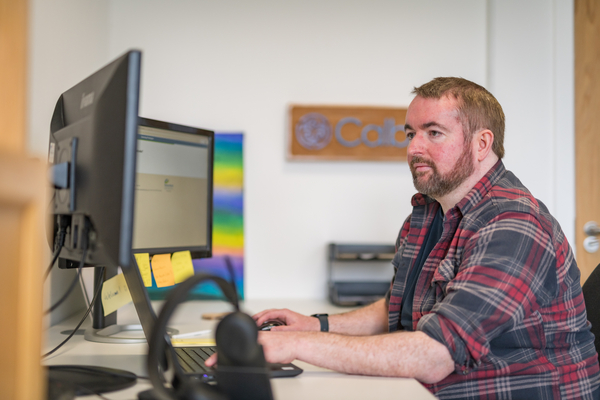 An image of our postgraduate alumni, Ricky, looking at his computer for the prepare for your application guide link. 