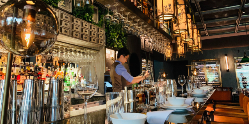 A barman working behind a bar.