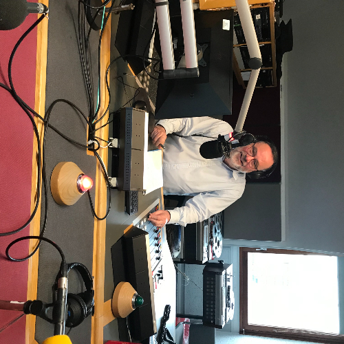 picture of Reporter Huw Williams sitting in the BBC Radio Orkney studio