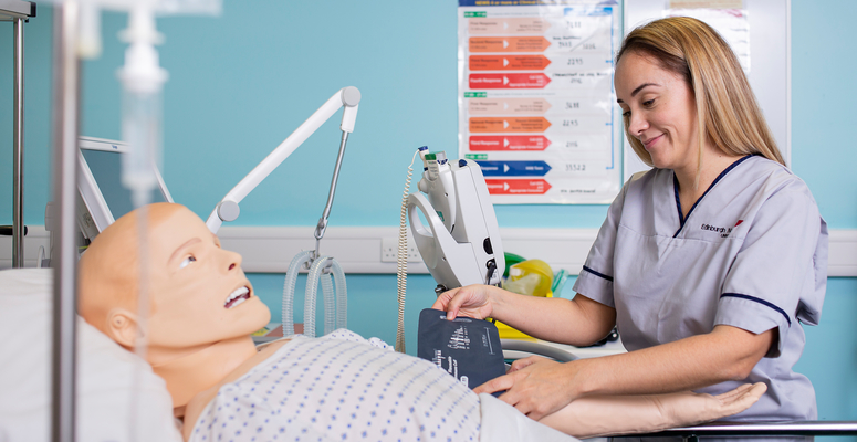 Nursing student, Cassandra Shaw, working on the simulation dummy