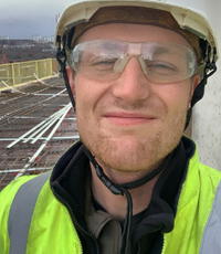 man with helmet and high-visibility shirt