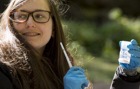 Student holding a water sample on Wildlife Biology and Conservation field trip