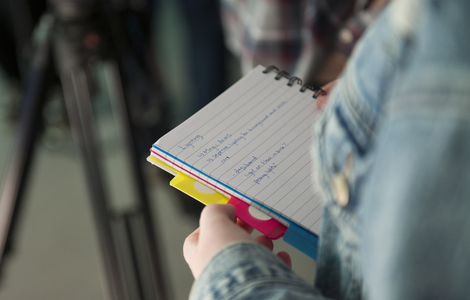 Close-up a student with notebook in their hands