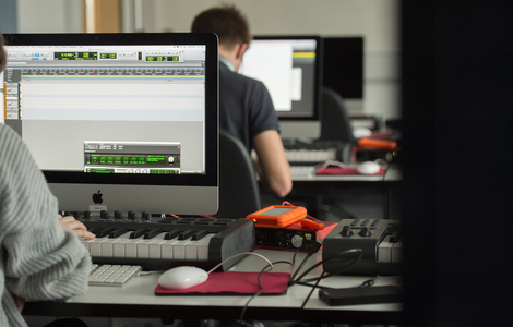 Students working on computers using Music software