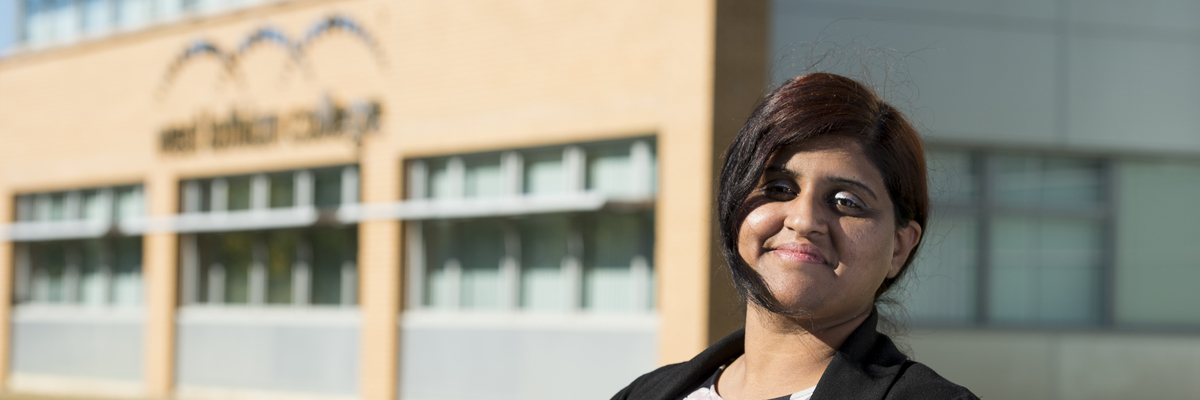 Edinburgh Napier Student smiling at the camera outside West Lothian College