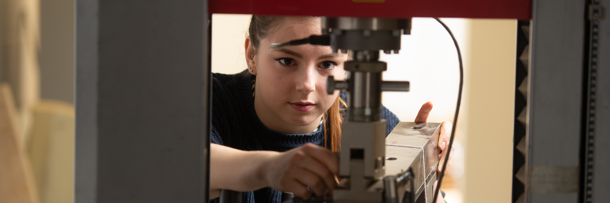 beX student working on a machine