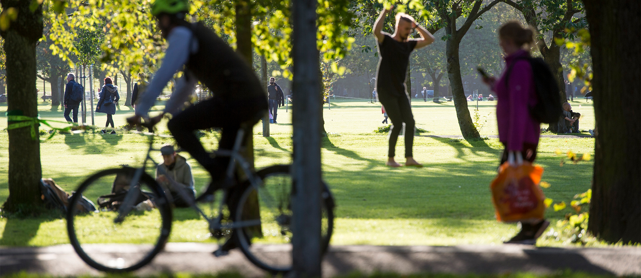 People walking and cycling through the Meadows