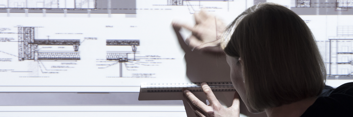 Architect pointing to part of a drawing of projected building plans