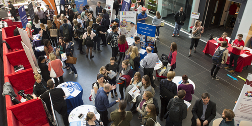 Crowd of people attending an event in the canteen space at Sighthill campus