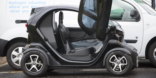 Photo of small electric car in front of hydrogen fuelled van