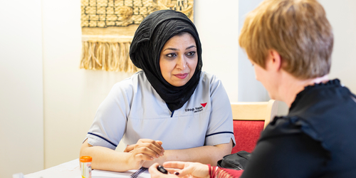 Female nursing student talking to a patient