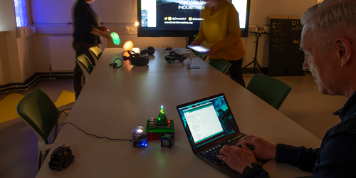 man coding lights from working on laptop