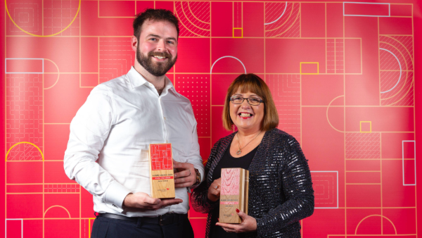 2023 Alumni Award winners Daniel Crehan and Isabel Dosser holding their trophies