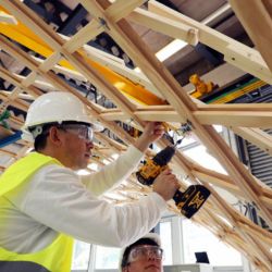 SCEBE students working on the construction of the Bamboo Gridshell at Merchiston.