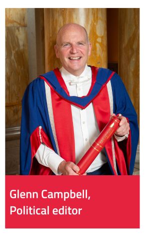 Honorary Graduate Glenn Campbell wearing gown and holding scroll 