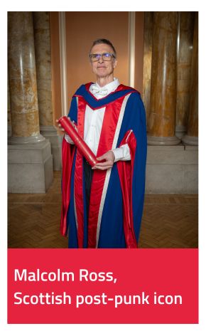 Honorary Graduate Malcolm Ross wearing gown and holding scroll 