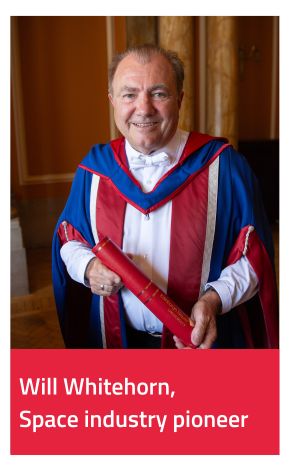 Honorary Graduate Will Whitehorn wearing gown and holding scroll