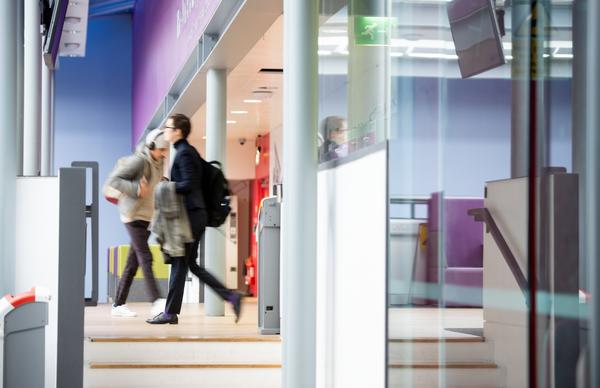 Students walking into the The Jack Kilby Computer Suite at Edinburgh Napier's Merchiston Campus. 