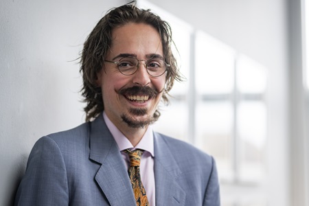 A headshot of Levente Hegedus smiling