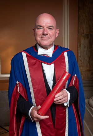 James Matthews standing with his honorary degree