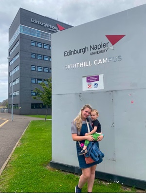Kirsty Dow holding her son outside Edinburgh Napier University's campus