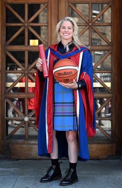 Robyn Love holding her degree and a basketball outside the Usher Hall