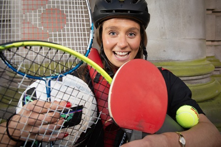 Lorna Husband holding a lot of sporting equipment