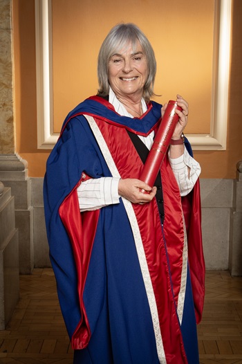 Susan Morrison holding her honorary doctorate inside the Usher Hall