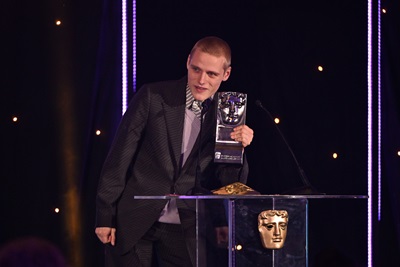 GLASGOW, SCOTLAND - NOVEMBER 19: Lewis Gribben accepts the Actor Television Award for 'Somewhere Boy' at the 2023 BAFTA Scotland Awards