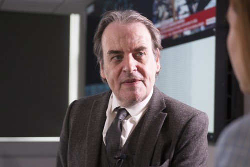 headshot of bill buchanan speaking to someone out of camera frame