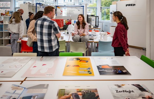 A photo of students and parents touring one of our design rooms at Edinburgh Napier's Merchiston campus, while chatting to lecturers and staff. 
