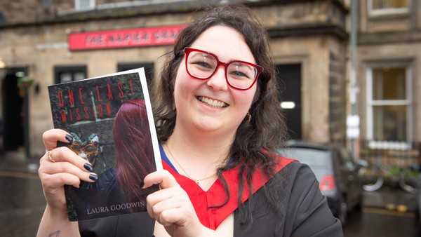 Laura Goodwin holding her book
