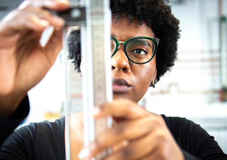 A person holding up a transparent object.