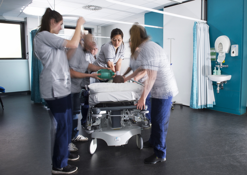 Nursing students practising on a dummy.