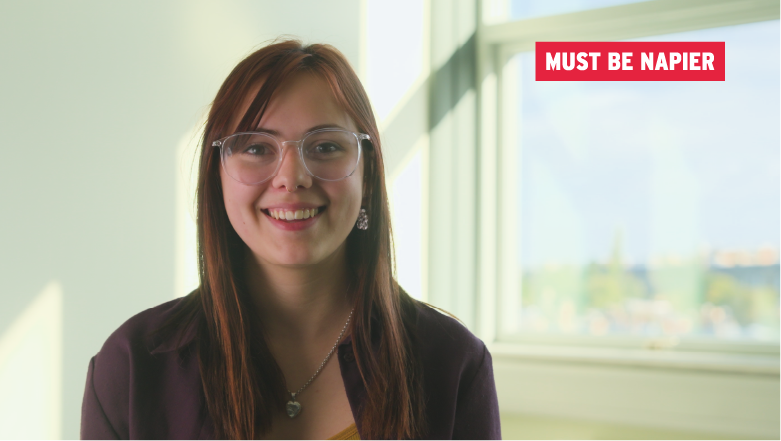 Smiling student near a window - with tagline: Must Be Napier