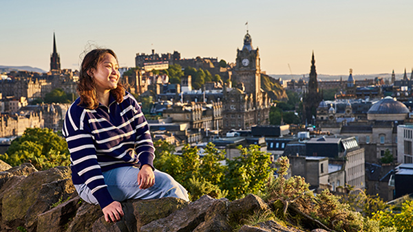 Smiling student relaxes on Calton Hill