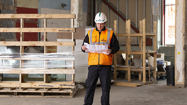 A building surveyor in hard hat and high visibility jacket