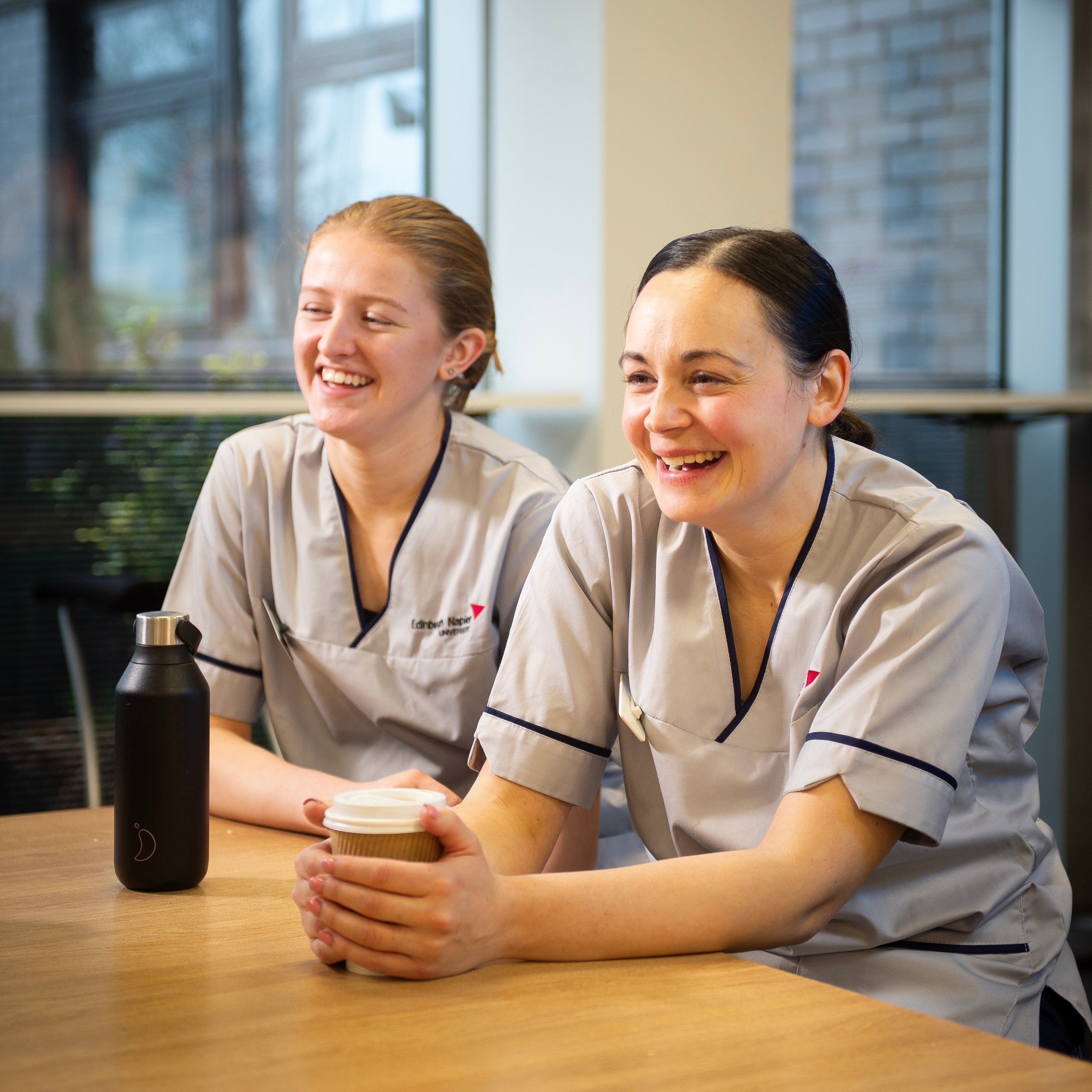 Two child health nursing students take a study break at Edinburgh Napier University's Sighthill campus cafeteria