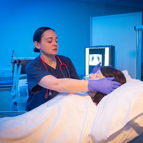 Sarah, a child health nursing student, checks on dummy patient in Edinburgh Napier University's Sighthill campus