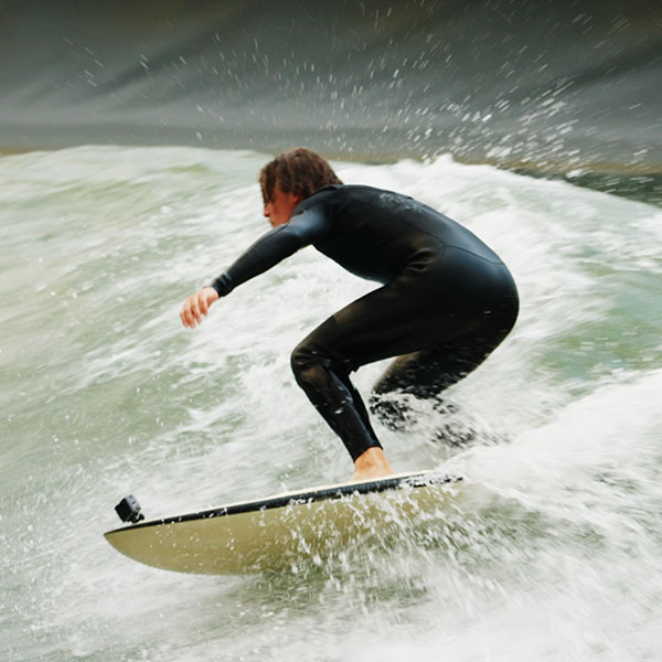 Surf club student at Edinburgh Napier University, rides a wave at Lost Shore UK wavepool