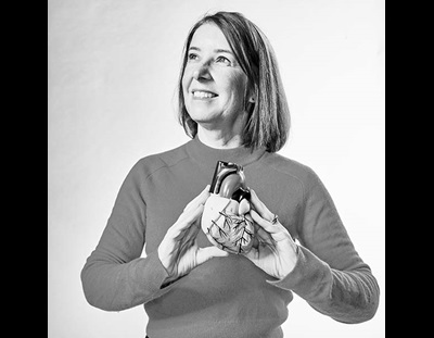 lis neubeck, professor of cardiovascular health and academic at Edinburgh Napier University, smiles and holds 3d model of heart