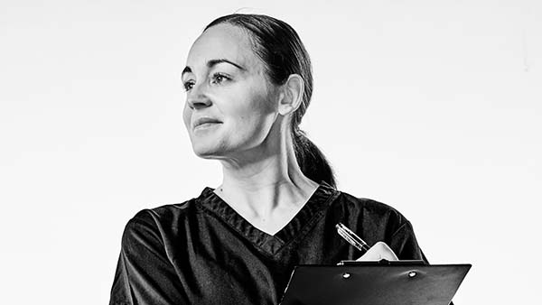 Sarah, child health nursing student, looks confident to the side